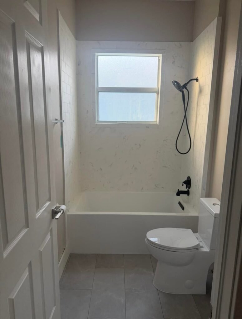 After: refreshed tub with new white wall surround
