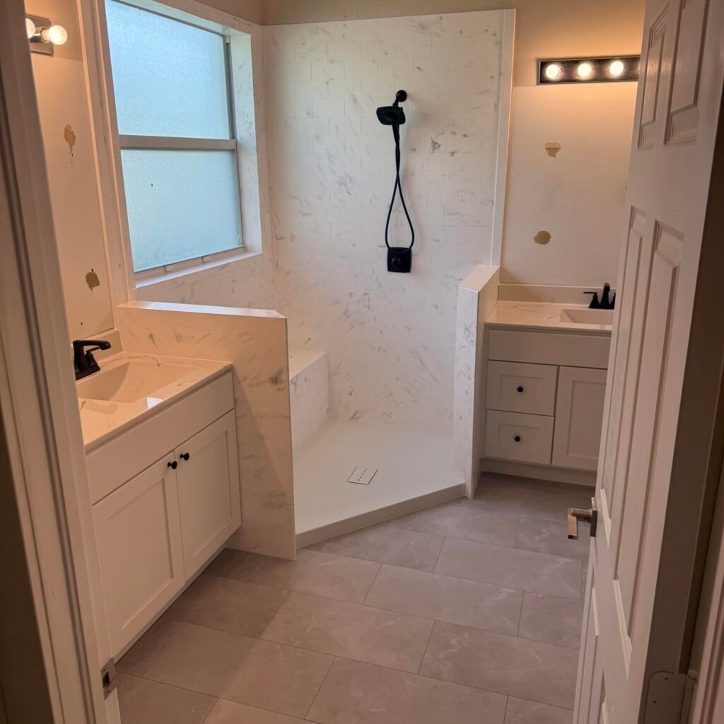 Remodeled bathroom with two vanities and walk-in shower